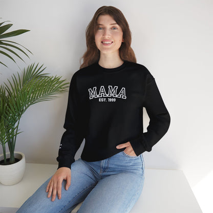 Black sweatshirt with 'MAMA EST. 1999' text worn by a person.
