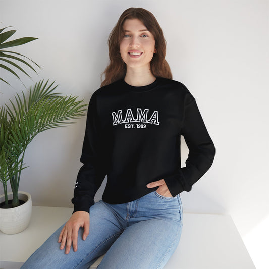Black sweatshirt with 'MAMA EST. 1999' text worn by a person.