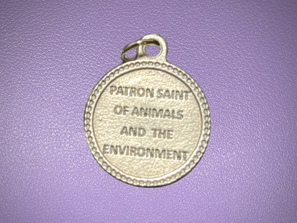 Medal with 'Patron Saint of Animals and the Environment' text on a purple background