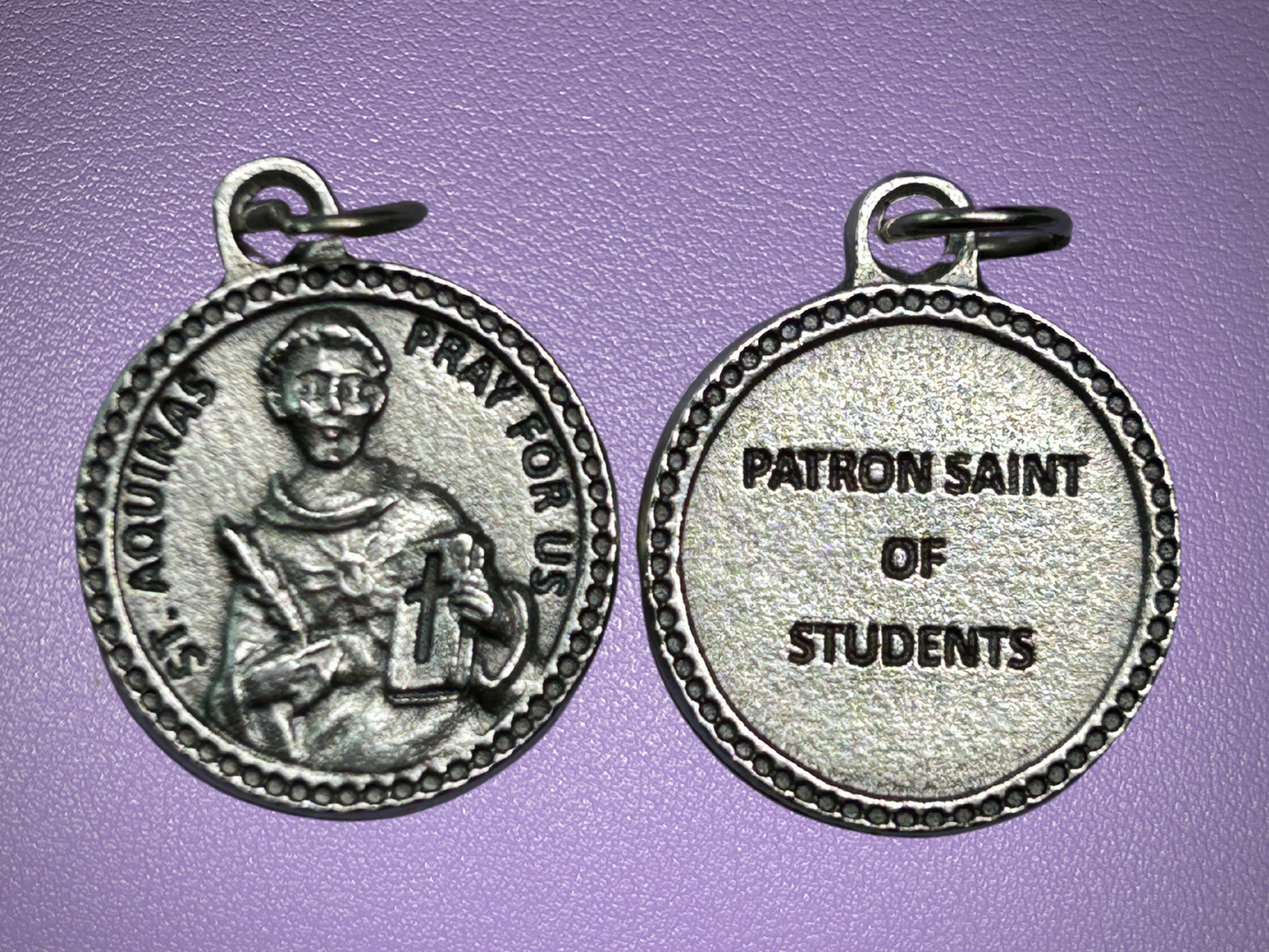 Silver medal with a portrait and text on a purple background