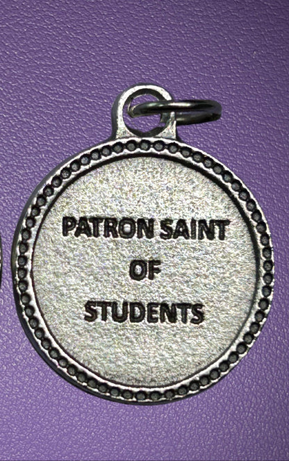 Medal with 'Patron Saint of Students' text on a purple background